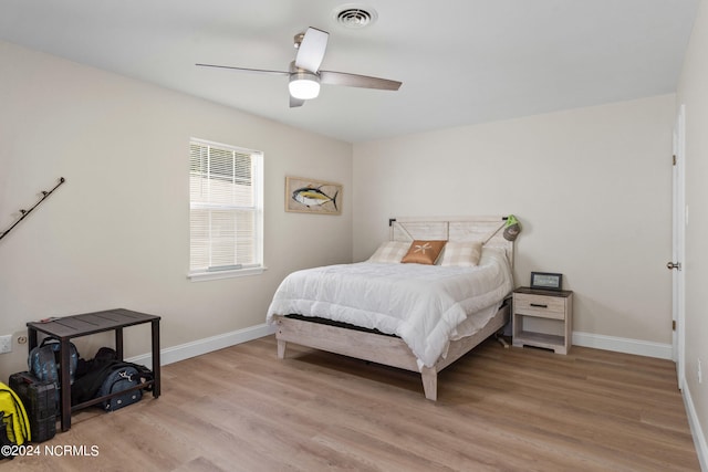 bedroom with light hardwood / wood-style flooring and ceiling fan