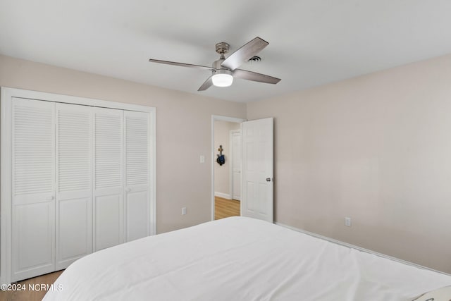 bedroom featuring a closet, wood-type flooring, and ceiling fan