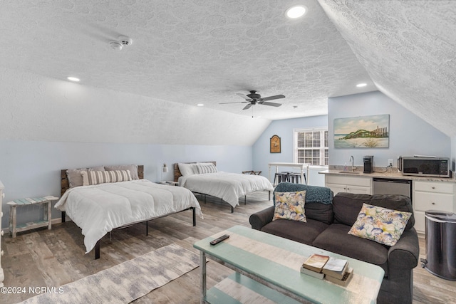 bedroom with sink, a textured ceiling, light hardwood / wood-style floors, and ceiling fan