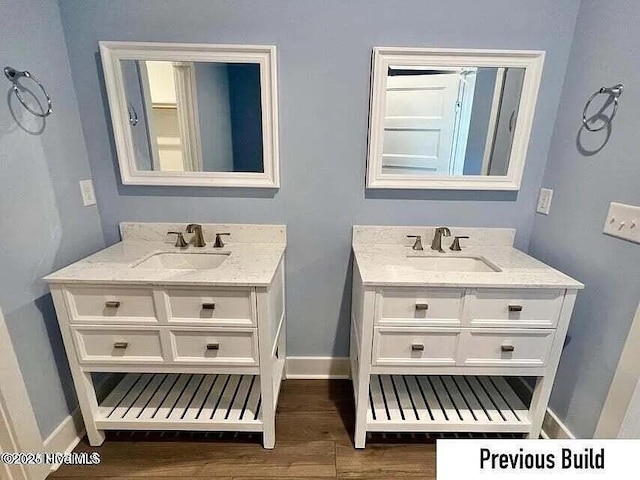 bathroom with wood-type flooring and vanity