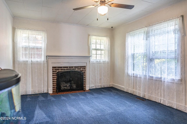 unfurnished living room with carpet, a fireplace, a healthy amount of sunlight, and ceiling fan