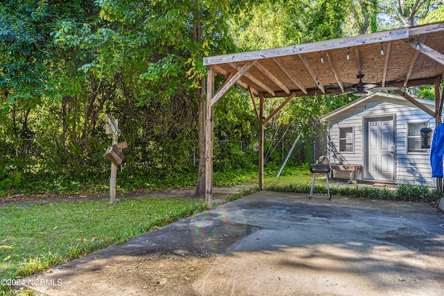 view of patio featuring a carport and a storage unit