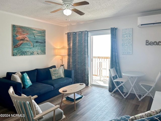 living room with a textured ceiling, a wall unit AC, wood-type flooring, and ceiling fan