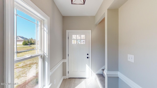 doorway to outside with light wood-type flooring