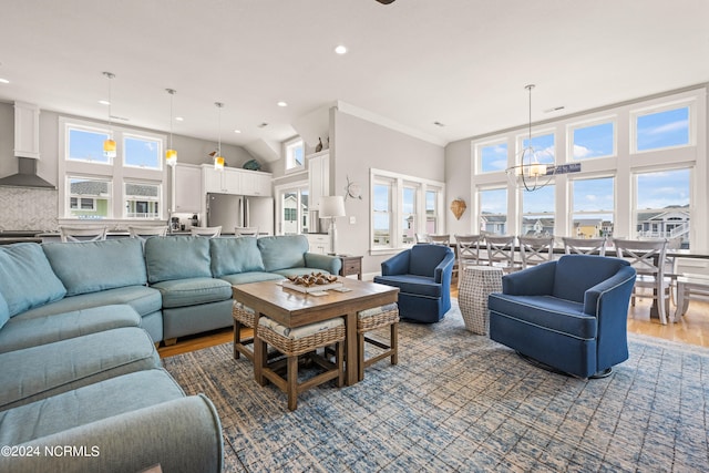 living room with hardwood / wood-style floors and an inviting chandelier