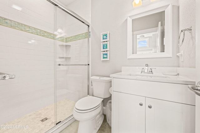 bathroom featuring vanity, toilet, and an enclosed shower