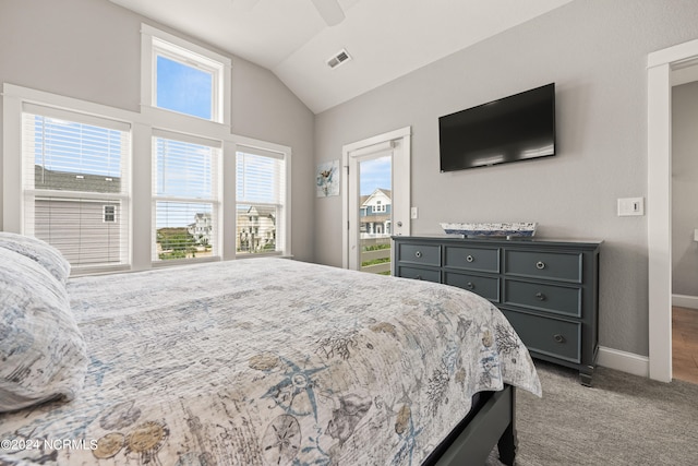 carpeted bedroom featuring vaulted ceiling, multiple windows, and ceiling fan