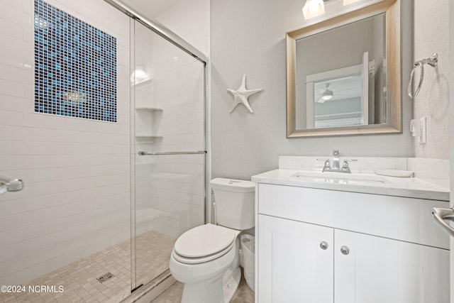 bathroom with walk in shower, vanity, and toilet