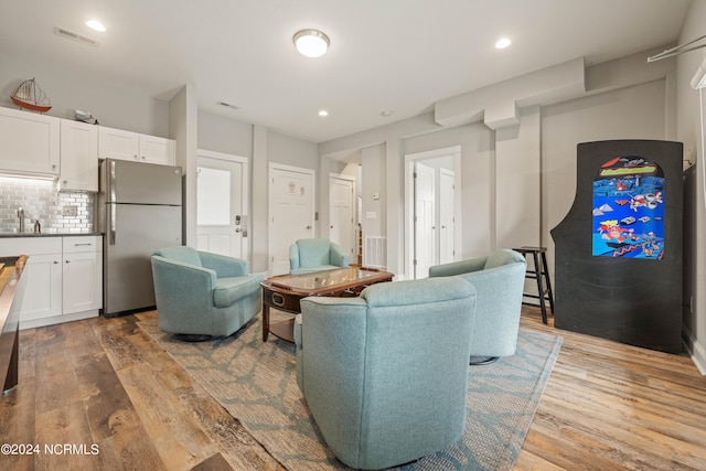 living room featuring hardwood / wood-style flooring and sink