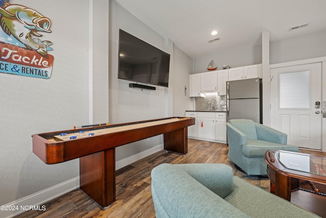 game room with dark hardwood / wood-style flooring and sink