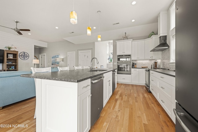 kitchen featuring hanging light fixtures, white cabinetry, sink, and stainless steel appliances