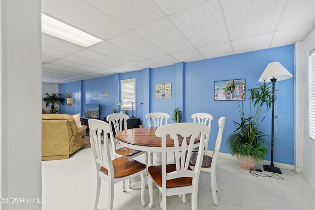 dining room featuring a drop ceiling