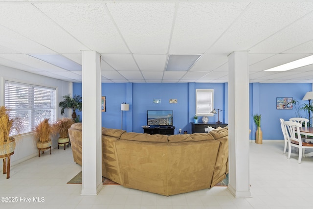 living room with a paneled ceiling