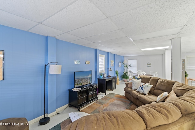 living room with a drop ceiling