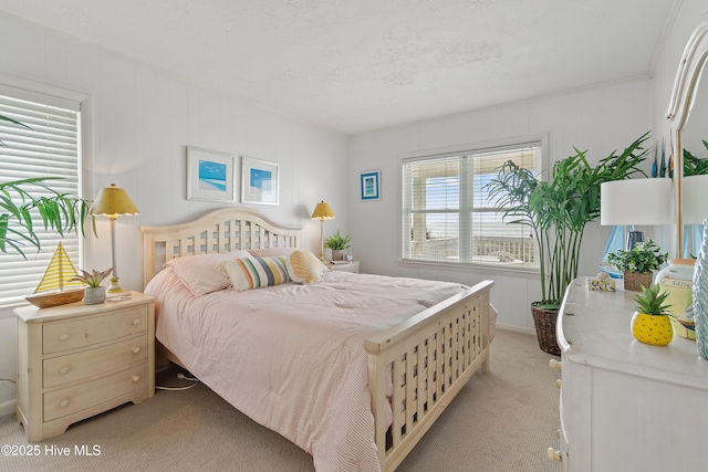 carpeted bedroom featuring multiple windows and a textured ceiling