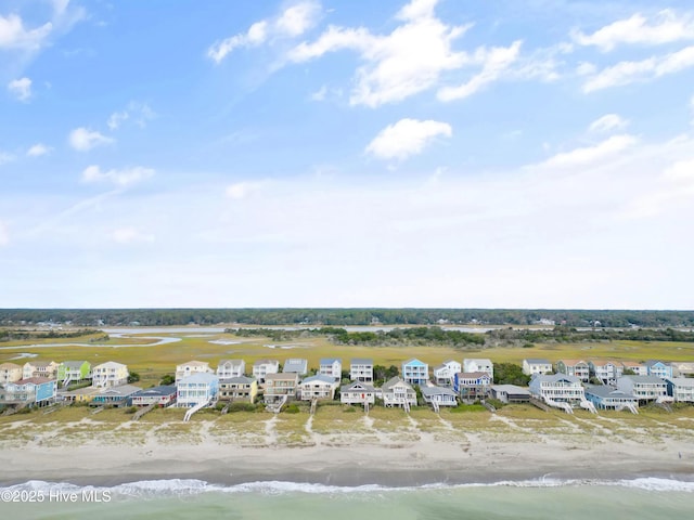 drone / aerial view with a water view and a view of the beach