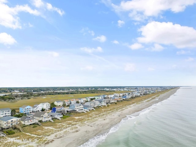 drone / aerial view with a water view and a beach view