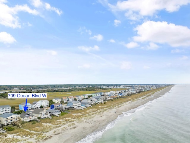 drone / aerial view featuring a water view and a beach view