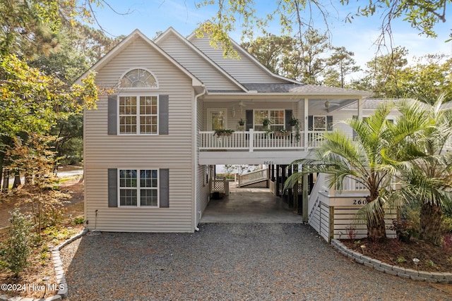 view of front of house featuring gravel driveway, covered porch, and a carport