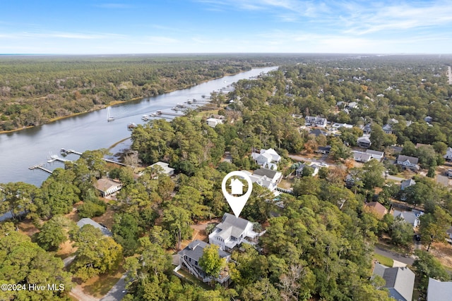 birds eye view of property featuring a water view, a residential view, and a wooded view