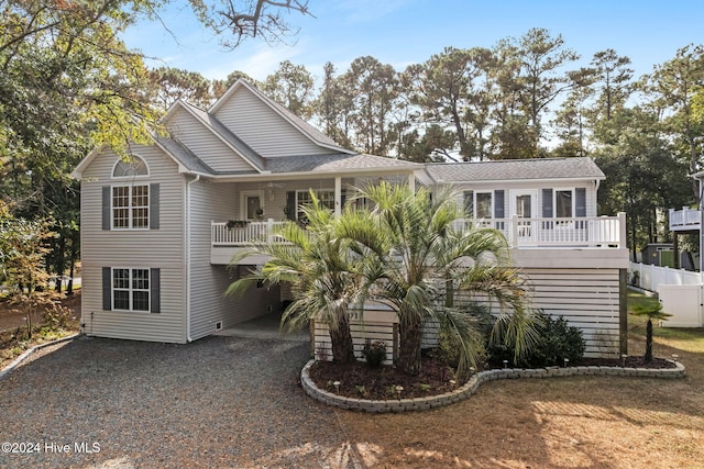 coastal home with driveway and fence