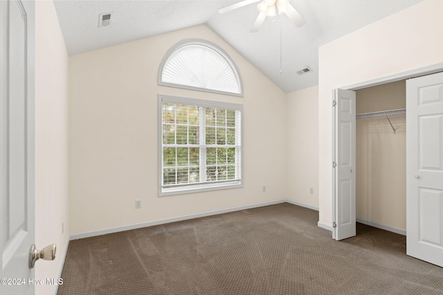 unfurnished bedroom featuring a closet, visible vents, light carpet, vaulted ceiling, and baseboards