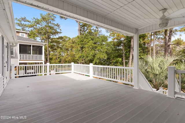 deck featuring a sunroom and ceiling fan