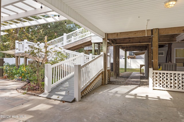 view of patio with central AC unit and stairway