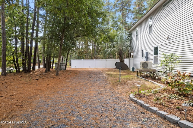 view of yard featuring ac unit and fence