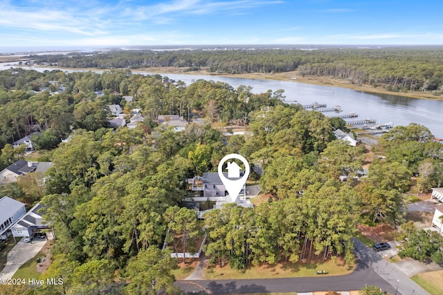 aerial view featuring a water view and a wooded view