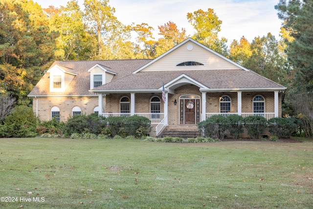 view of front of home featuring covered porch and a front lawn