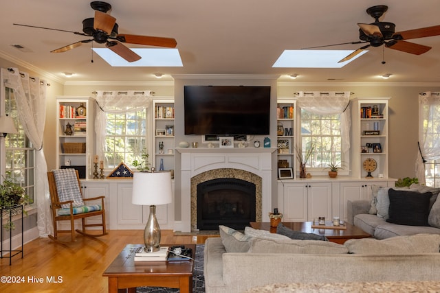 living room with ornamental molding, light wood-type flooring, and ceiling fan