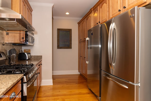 kitchen featuring light stone counters, backsplash, light hardwood / wood-style flooring, stainless steel appliances, and ventilation hood