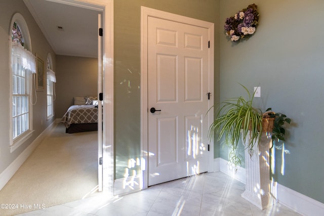 entrance foyer featuring light colored carpet