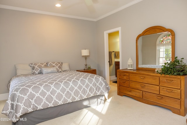 bedroom featuring ensuite bathroom, crown molding, light colored carpet, and ceiling fan