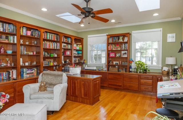 office area featuring light hardwood / wood-style floors, ornamental molding, plenty of natural light, and ceiling fan