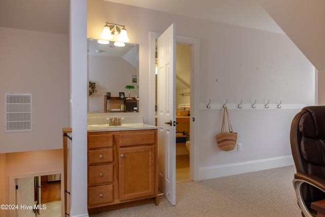 bathroom with vanity, toilet, and vaulted ceiling