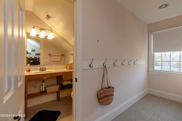 bathroom featuring lofted ceiling