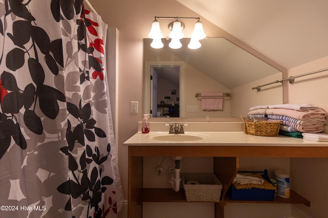 bathroom featuring vanity, walk in shower, and vaulted ceiling