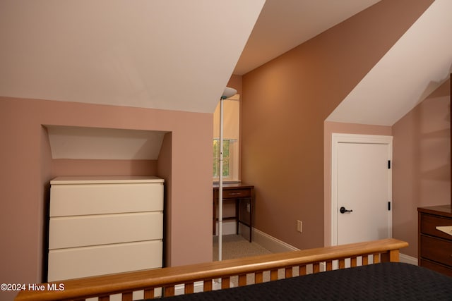 unfurnished bedroom featuring lofted ceiling