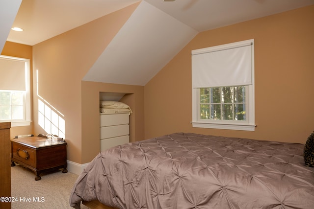 bedroom featuring vaulted ceiling and light colored carpet