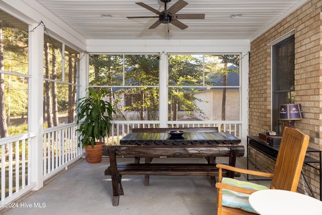 sunroom / solarium with ceiling fan and wooden ceiling