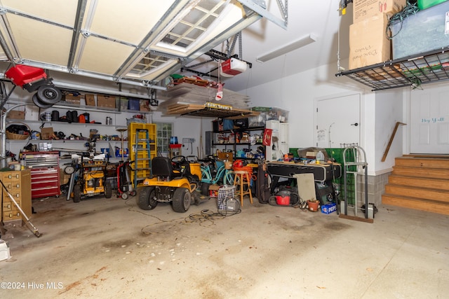 garage featuring a garage door opener and a workshop area