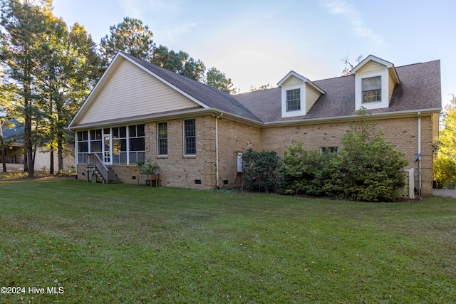 view of front of property with a front yard and a sunroom