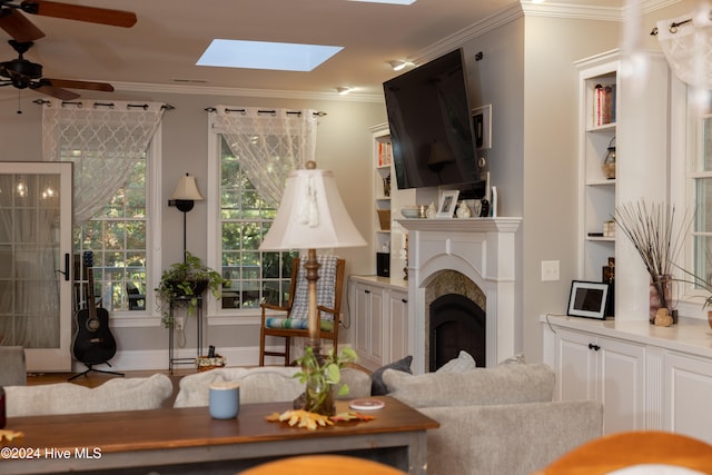 living room with crown molding and ceiling fan