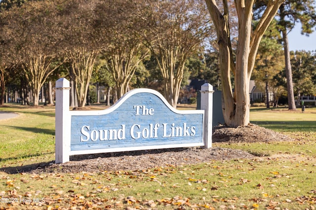 community / neighborhood sign with a lawn