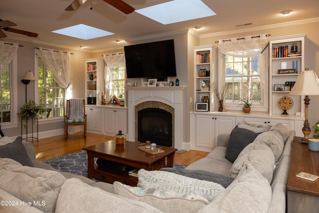 living room featuring crown molding, hardwood / wood-style flooring, and ceiling fan