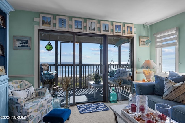 living room featuring a water view and carpet floors