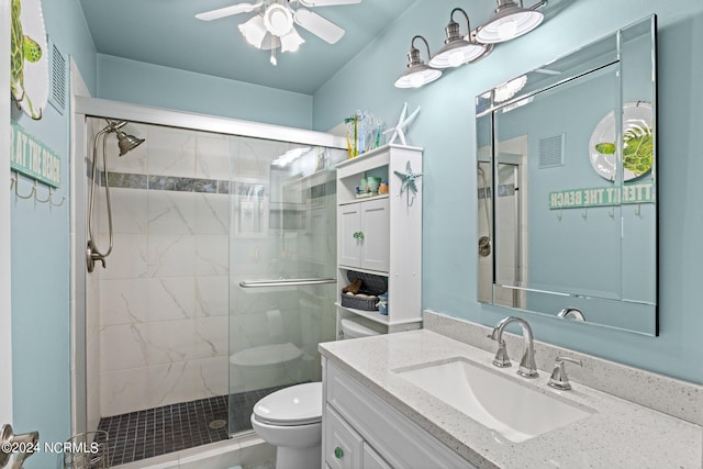 bathroom featuring vanity, ceiling fan, toilet, and walk in shower