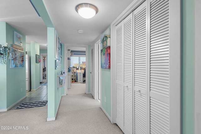 hall featuring light colored carpet